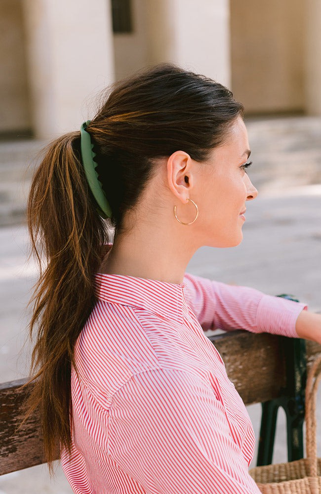 French woman sitting on bench wearing an L. Erickson Zodia, Matte Mint Green Banana Hair Clip with Double Rows of Teeth for Secure Hold