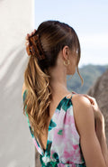 large claw hair clip holding hair at the back of the head