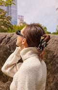 Large cutout rectangle jaw hair clip holding up hair in a loose twist.